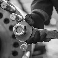 Hand tightening a bolt with a wrench